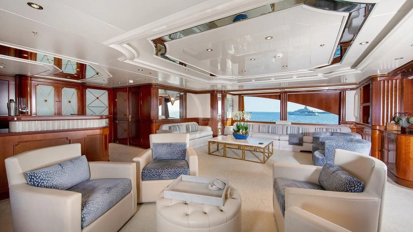 a room with a pool table and couches aboard NEXT CHAPTER Yacht for Sale