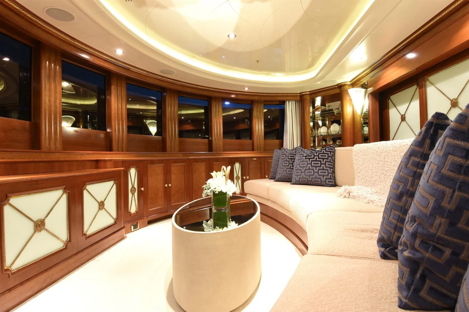 a room with a couch and a table with a vase of flowers aboard NEXT CHAPTER Yacht for Sale