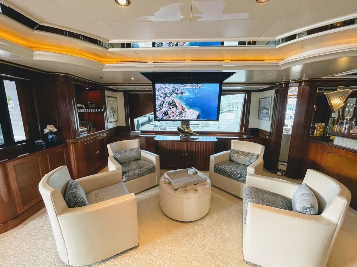 a living room with a large screen aboard NEXT CHAPTER Yacht for Sale
