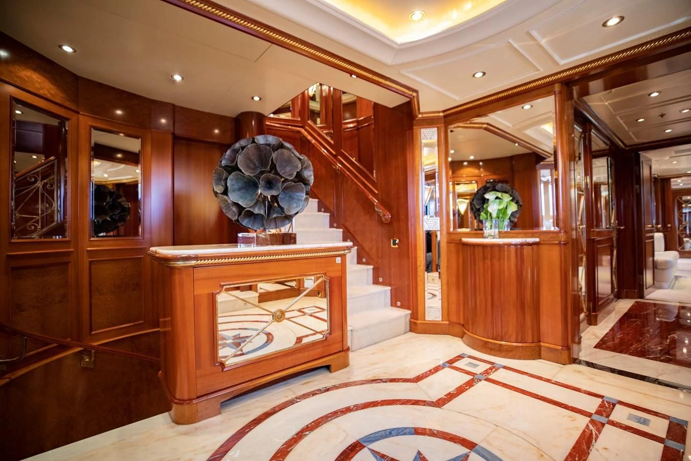a room with a wood table and a large mirror aboard NEXT CHAPTER Yacht for Sale