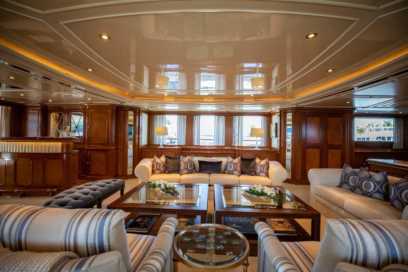 a living room with a large chandelier aboard NEXT CHAPTER Yacht for Sale