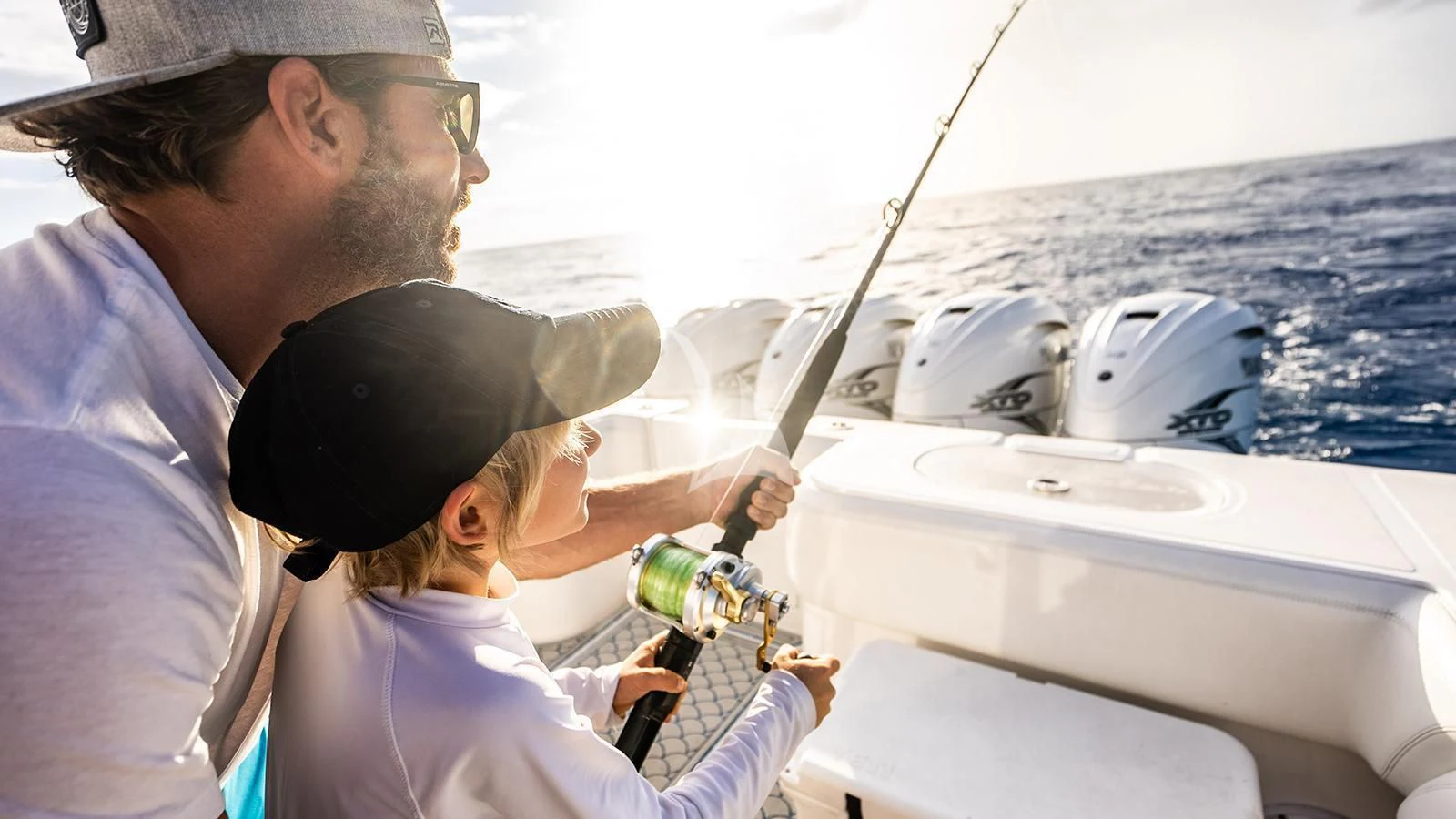 a man and a woman on a boat looking at a fishing pole aboard NEXT CHAPTER Yacht for Sale