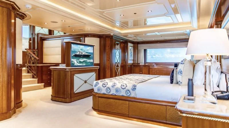 a bedroom with a bed and a tv aboard NEXT CHAPTER Yacht for Sale