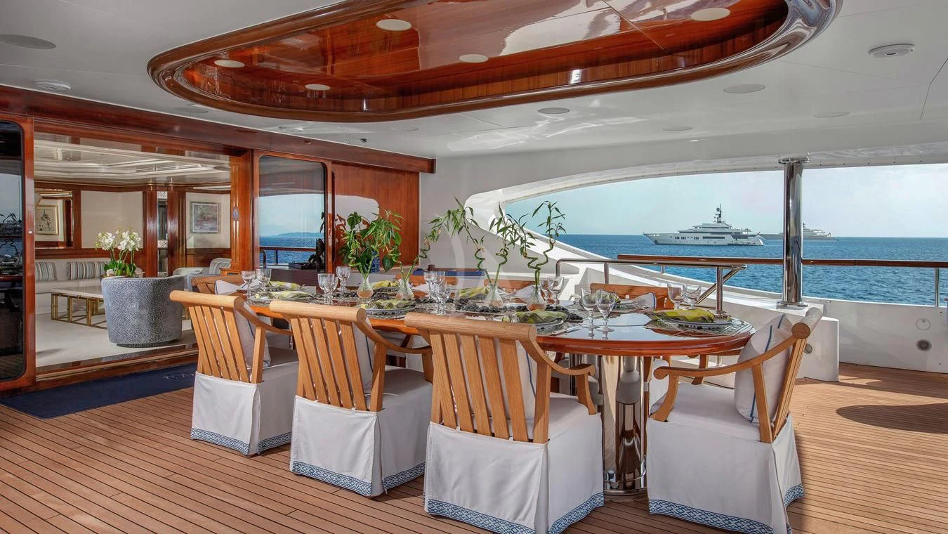a dining table on a deck aboard NEXT CHAPTER Yacht for Sale