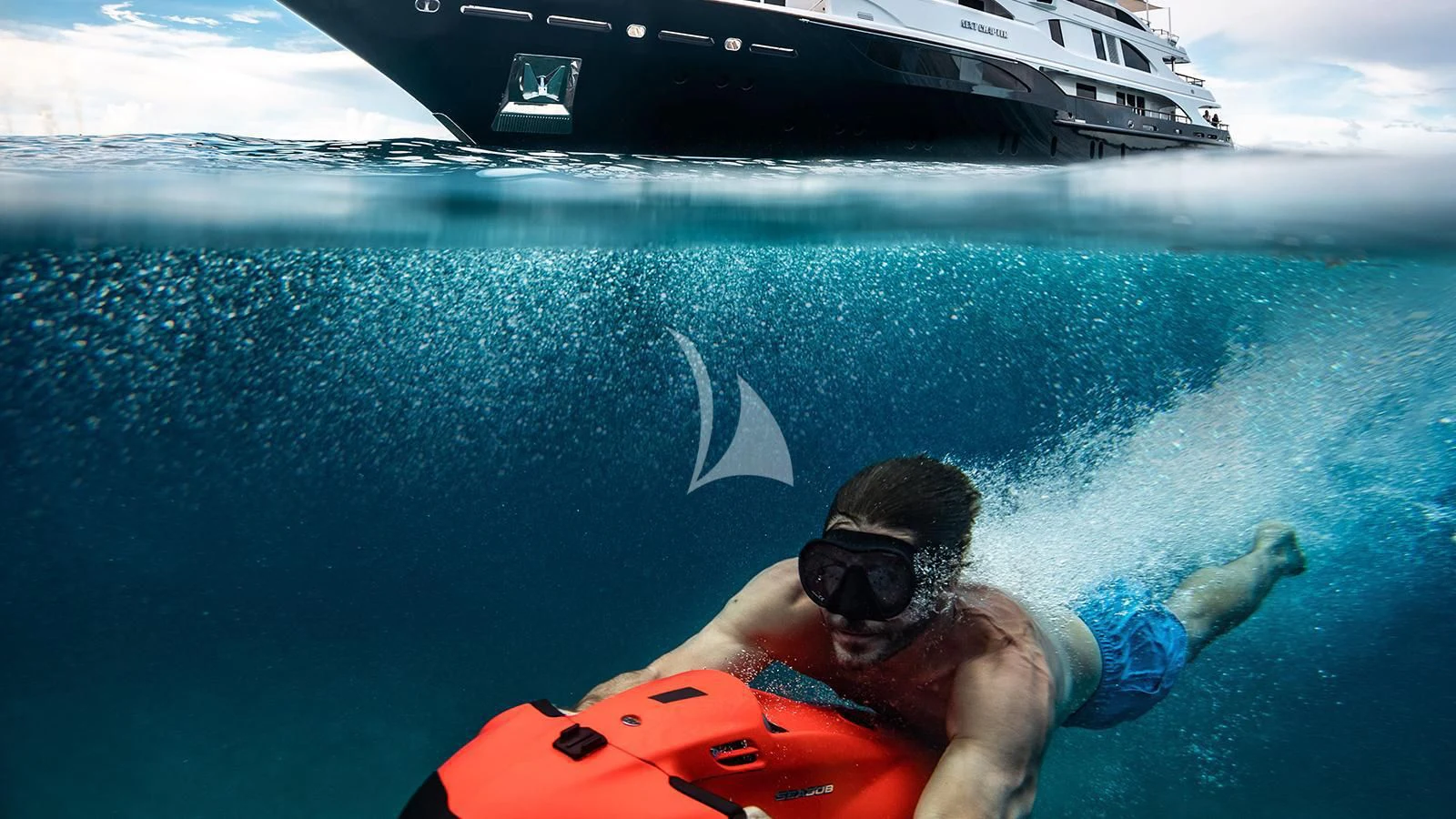 a man swimming in water with a boat in the background aboard NEXT CHAPTER Yacht for Sale