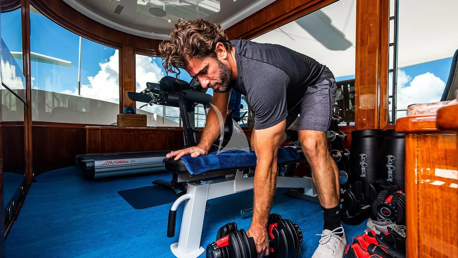 a man working out on a treadmill aboard NEXT CHAPTER Yacht for Sale