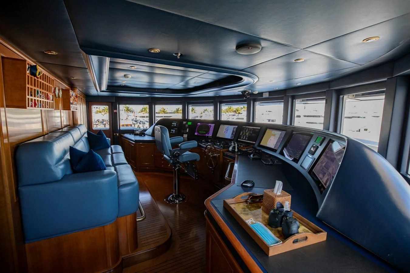 a room with a couch and a table with computers on it aboard NEXT CHAPTER Yacht for Sale
