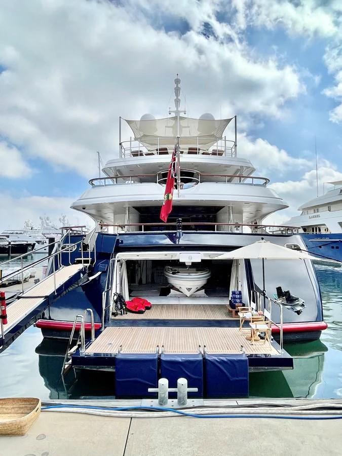 a large white boat with a red ribbon on it aboard NEXT CHAPTER Yacht for Sale