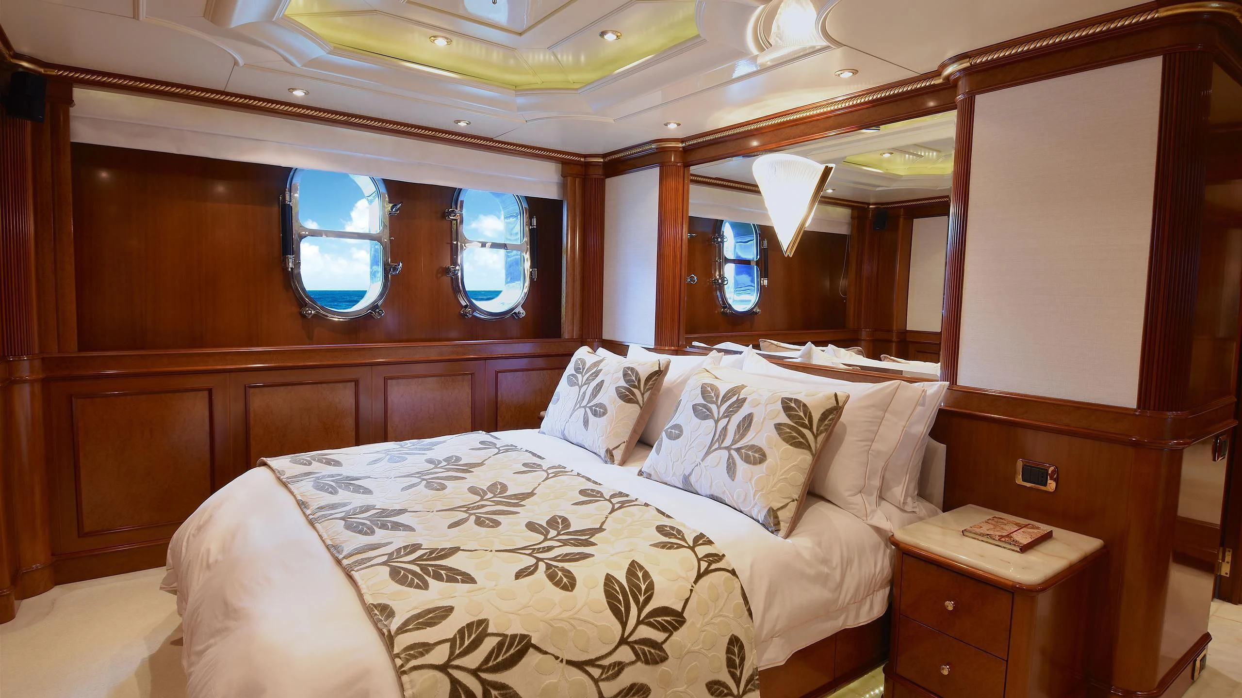a bed with a white comforter aboard NEXT CHAPTER Yacht for Sale