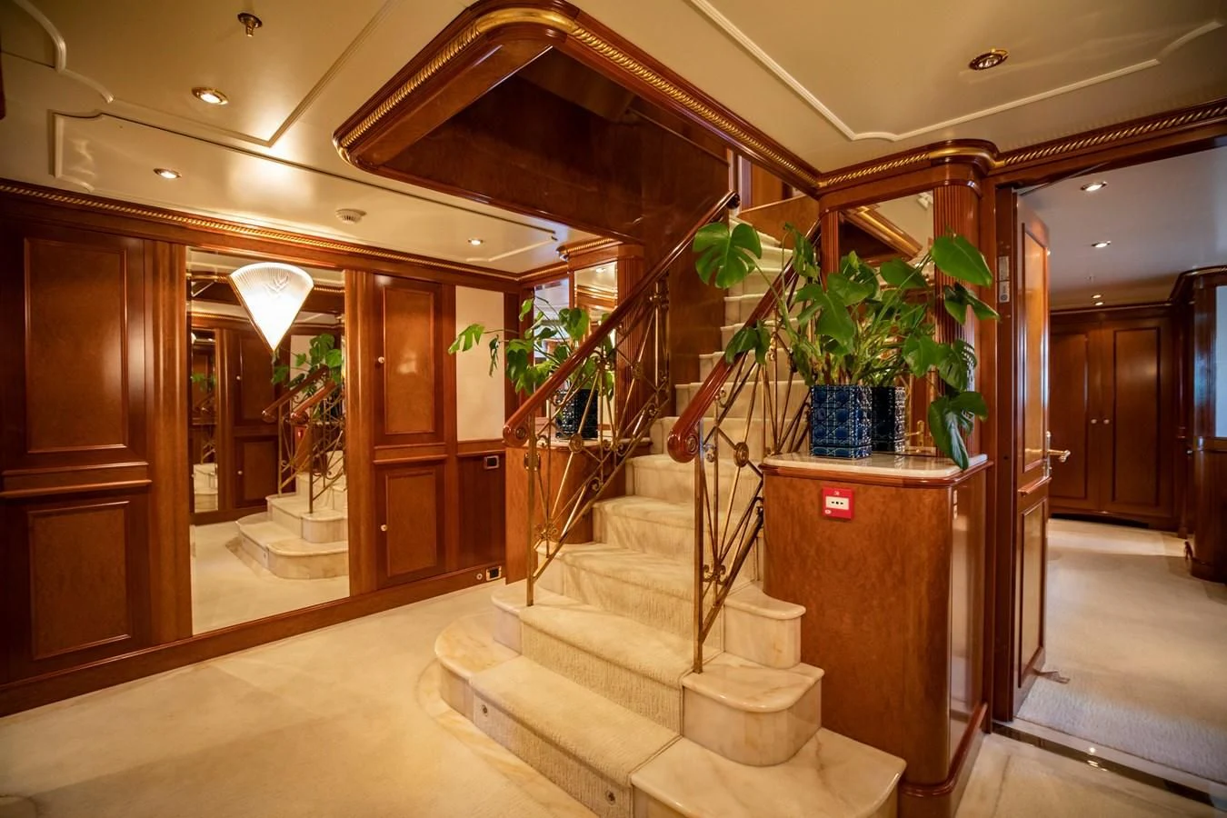 a hallway with stairs and plants aboard NEXT CHAPTER Yacht for Sale