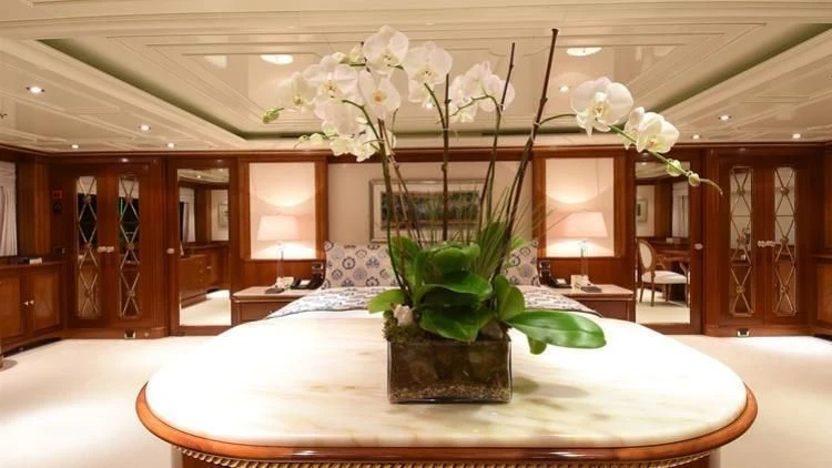 a vase of white flowers on a table aboard NEXT CHAPTER Yacht for Sale