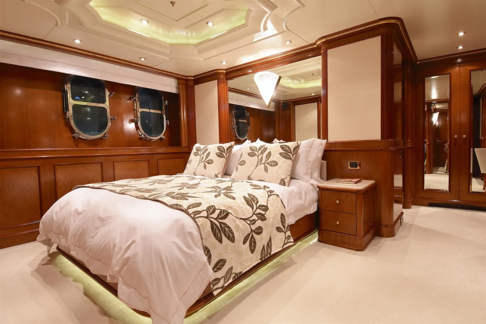 a room with a bed and a mirror aboard NEXT CHAPTER Yacht for Sale