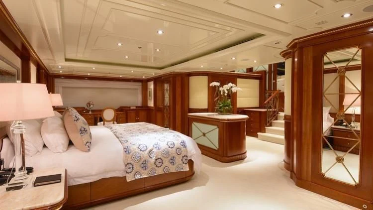 a bedroom with a bed and a mirror aboard NEXT CHAPTER Yacht for Sale