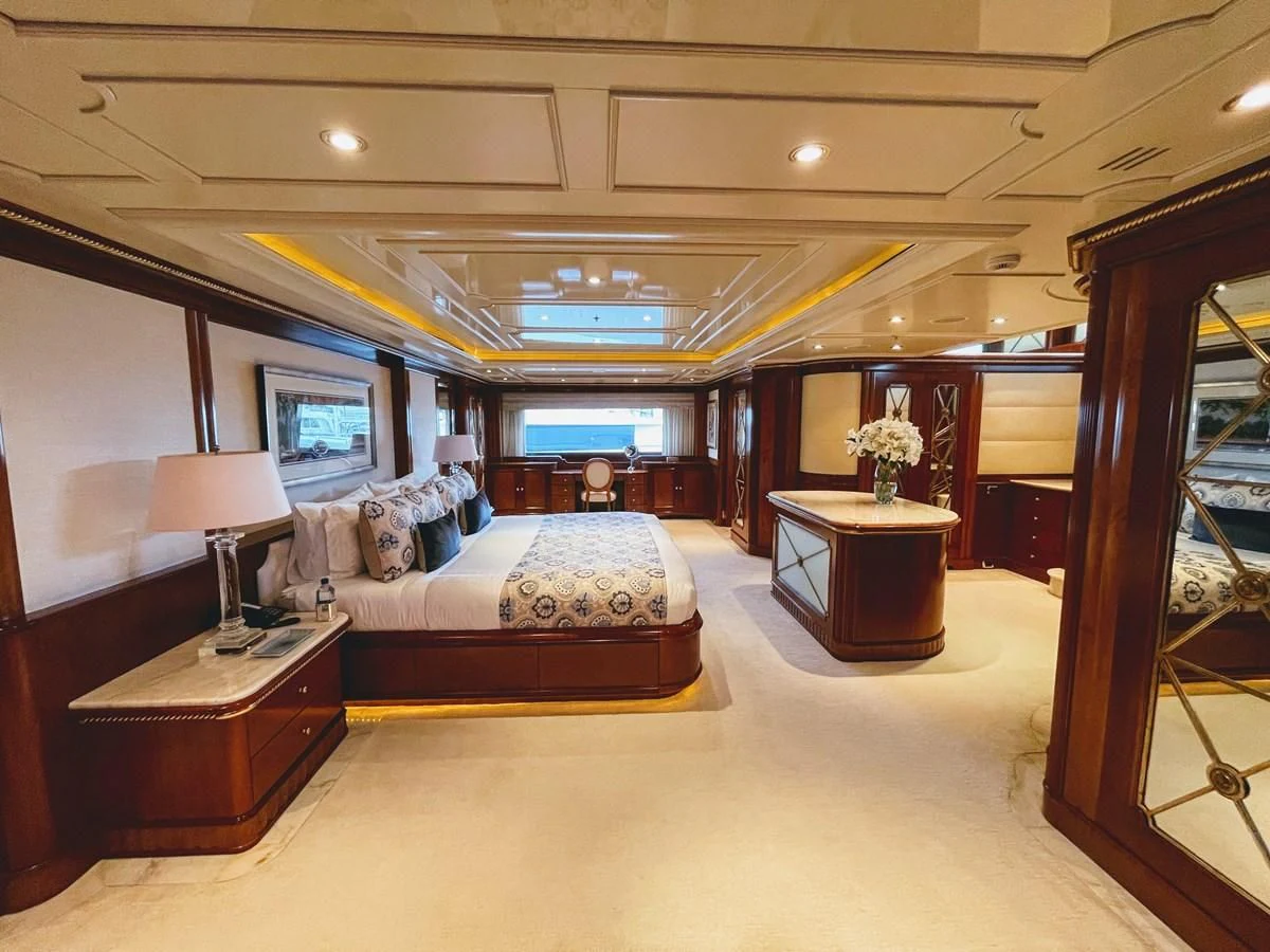 a large room with a bed and a desk aboard NEXT CHAPTER Yacht for Sale
