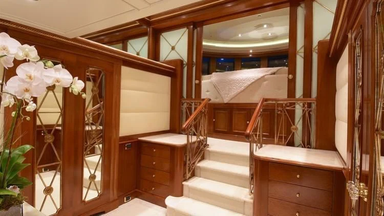 a room with a bed and a mirror aboard NEXT CHAPTER Yacht for Sale