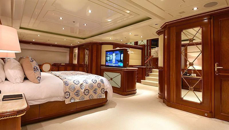 a bedroom with a bed and a tv aboard NEXT CHAPTER Yacht for Sale