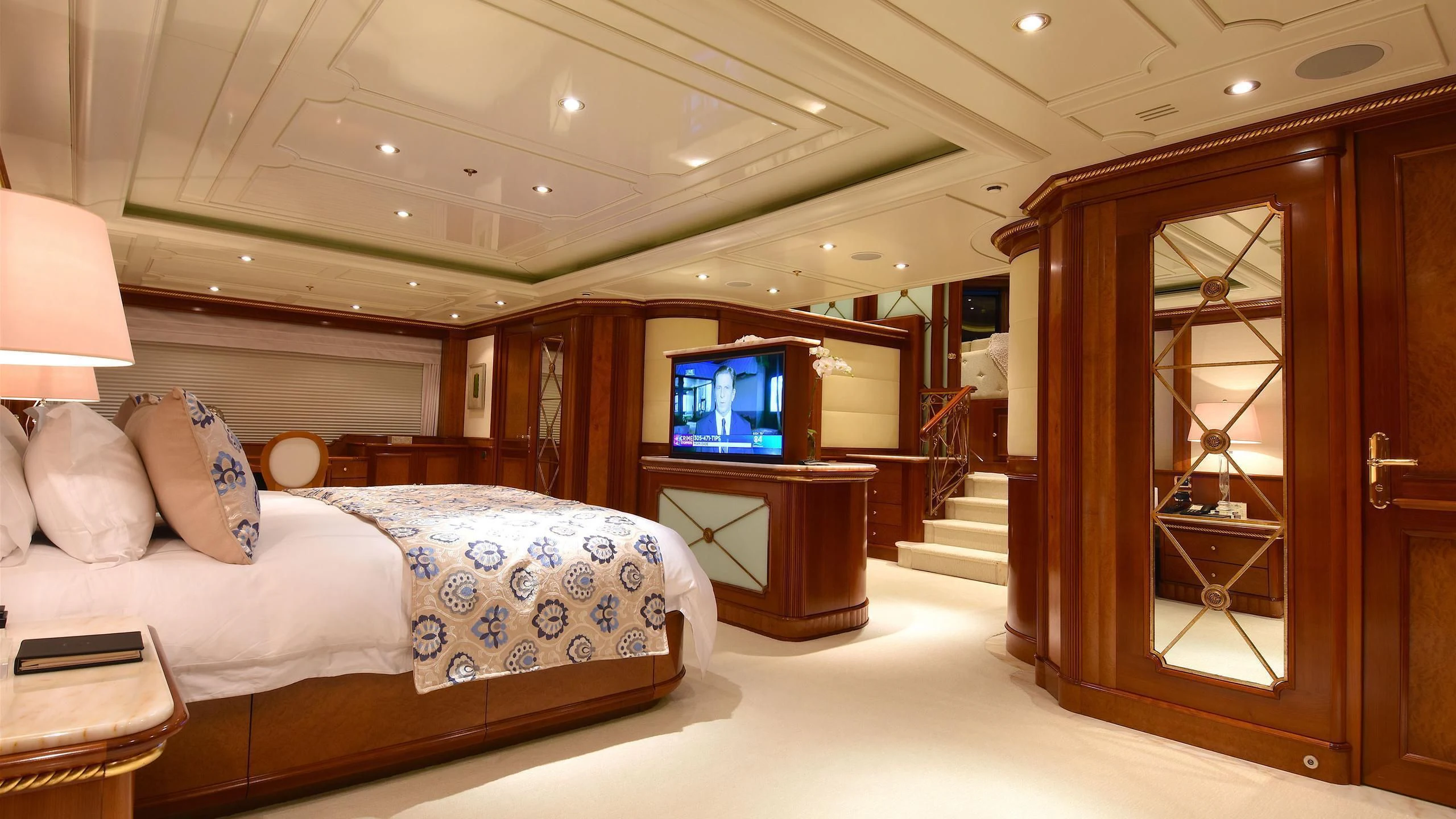 a bedroom with a bed and a tv aboard NEXT CHAPTER Yacht for Sale