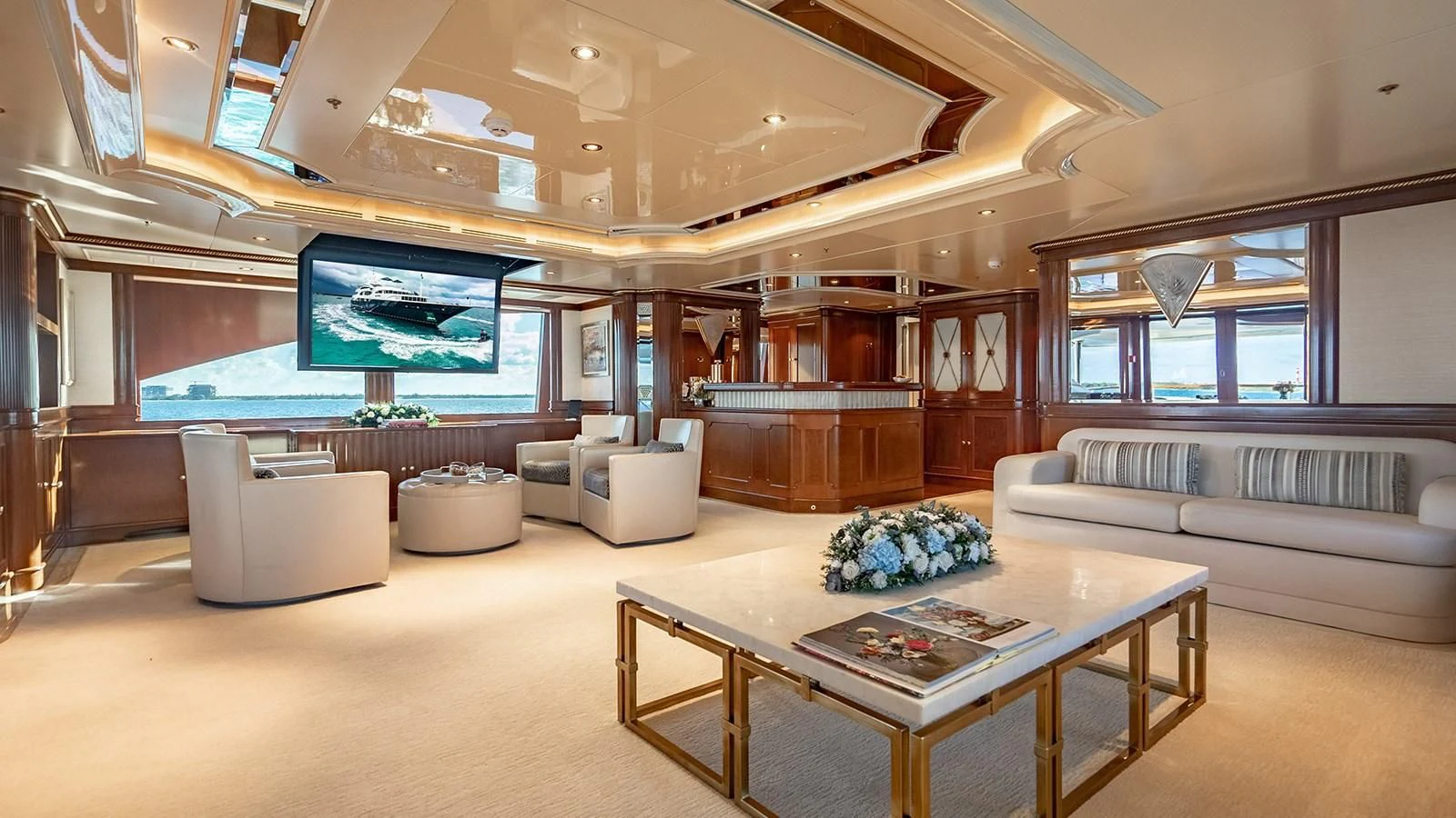 a large living room with a large screen aboard NEXT CHAPTER Yacht for Sale