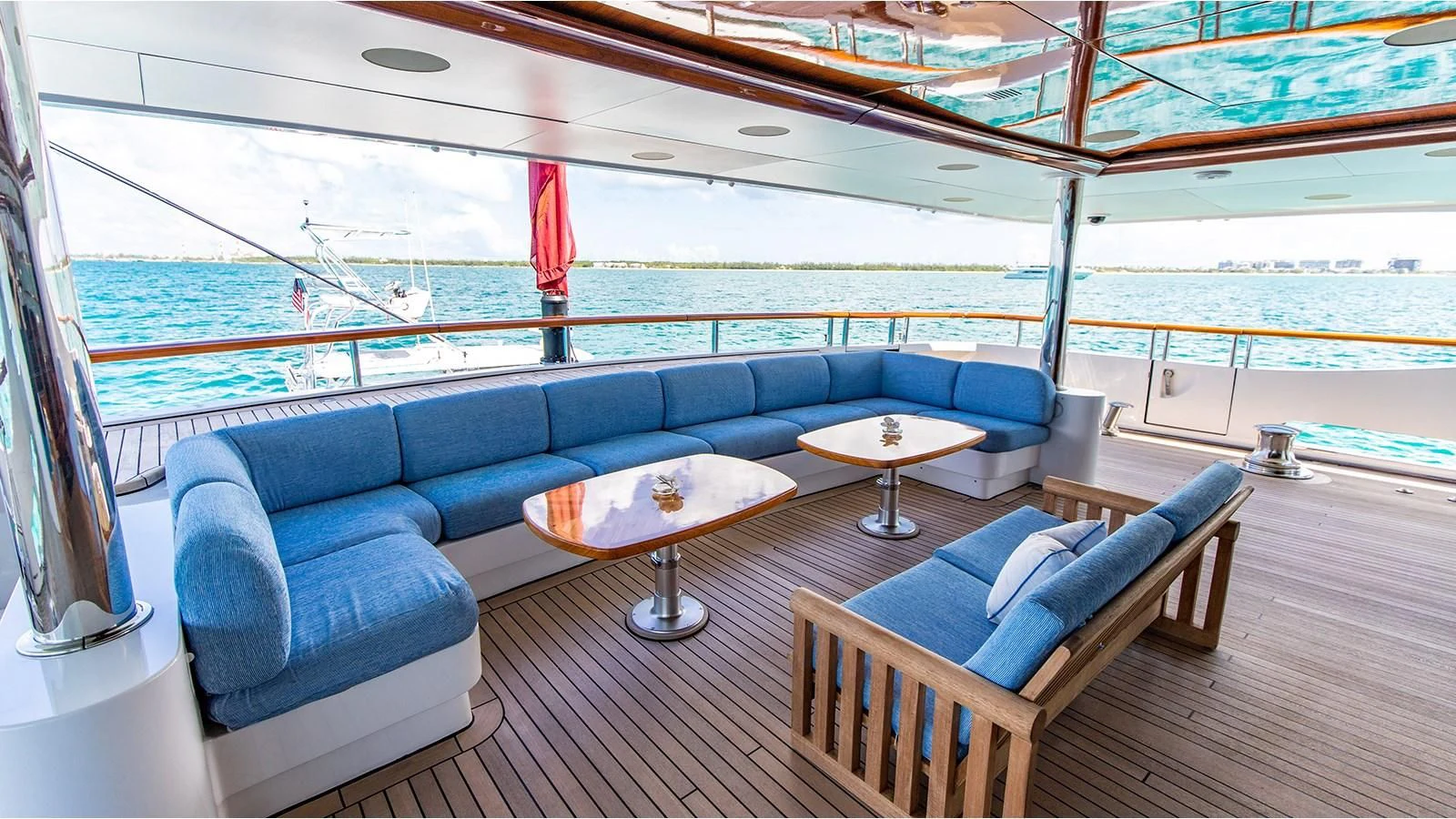 a room with a couch and a table and a view of the water aboard NEXT CHAPTER Yacht for Sale
