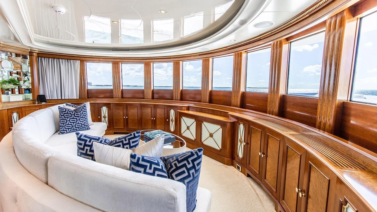 a large room with a couch and a window aboard NEXT CHAPTER Yacht for Sale