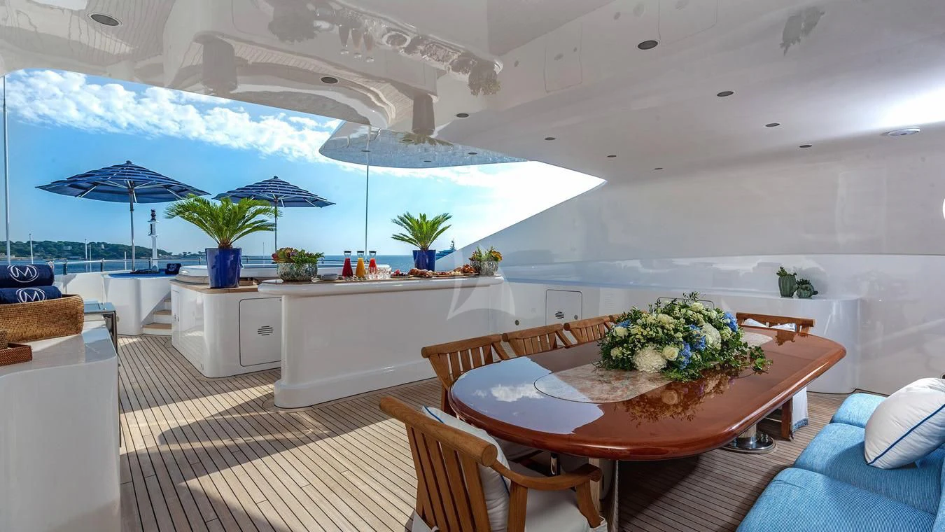 a room with a table and chairs aboard NEXT CHAPTER Yacht for Sale