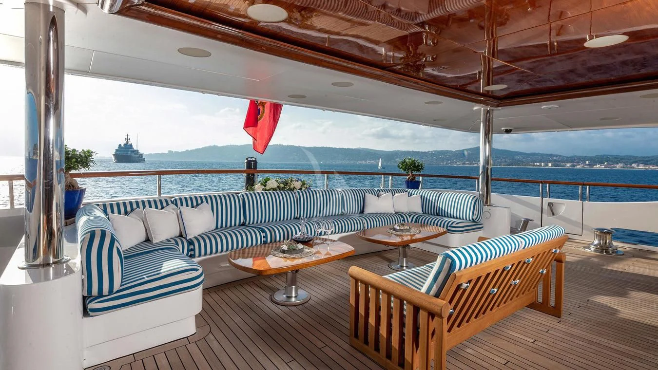 a patio with a table and chairs aboard NEXT CHAPTER Yacht for Sale
