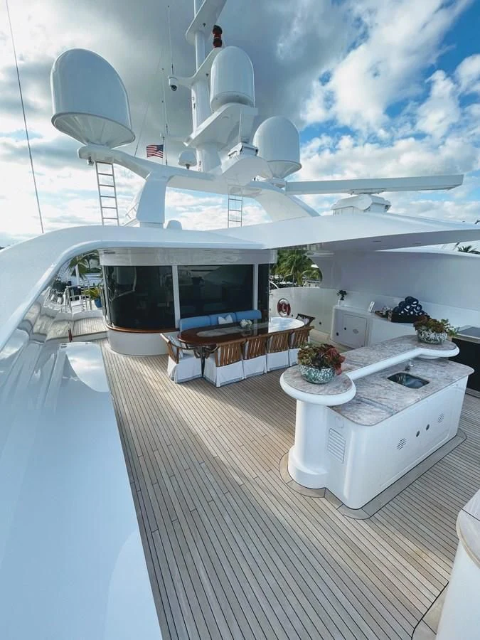 a boat with a table and chairs on the deck aboard NEXT CHAPTER Yacht for Sale