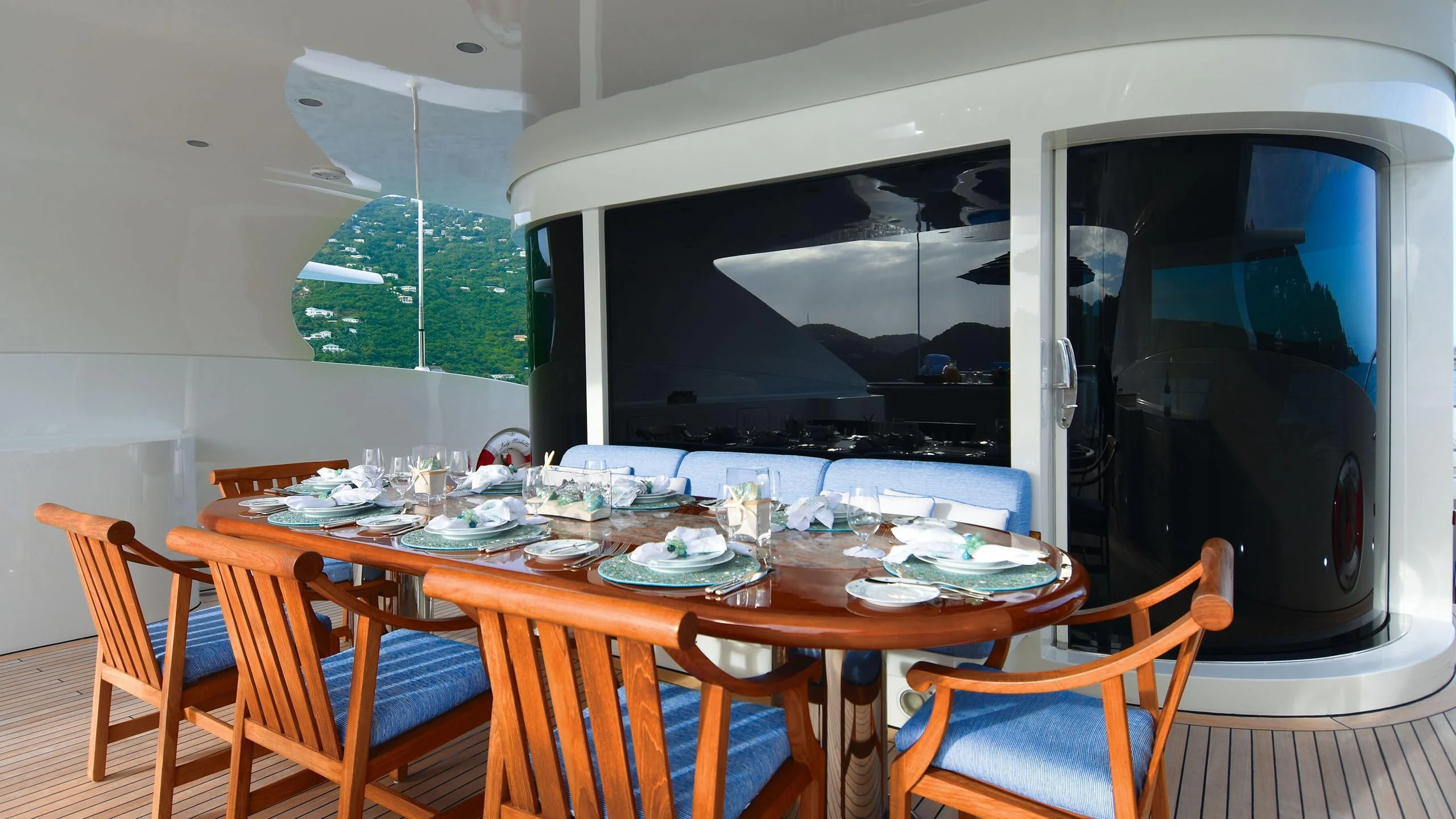 a dining table with chairs and a large black screen aboard NEXT CHAPTER Yacht for Sale