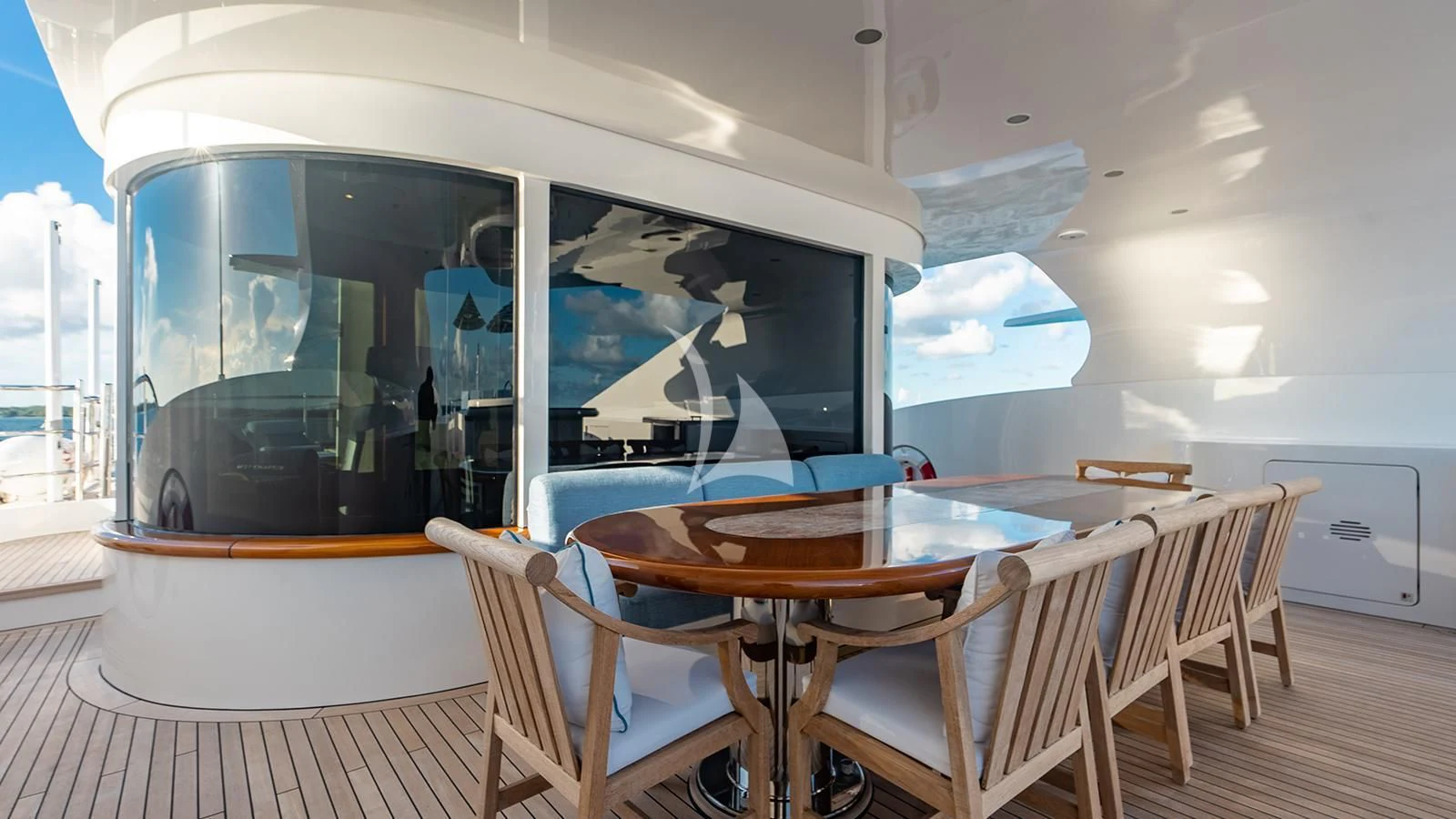a dining table and chairs in a room with a large window aboard NEXT CHAPTER Yacht for Sale