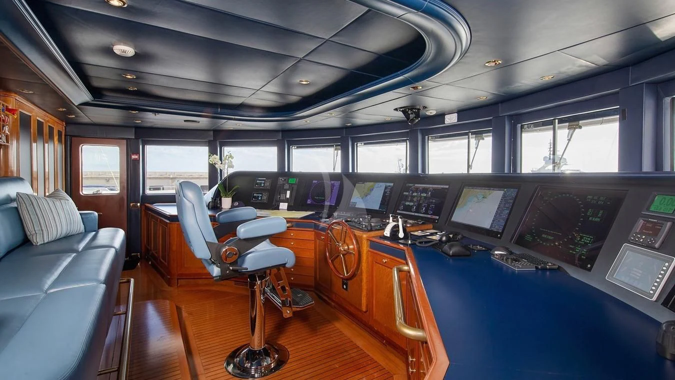 inside of a vehicle with a desk and chairs and a computer on the table aboard NEXT CHAPTER Yacht for Sale