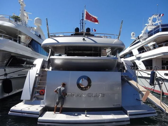 a person standing on a boat aboard OCEAN CLUB Yacht for Sale