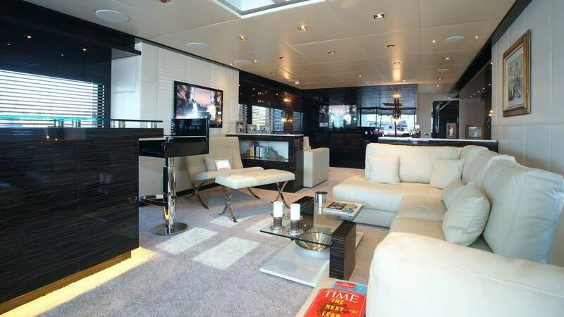 a living room with a large window aboard OCEAN CLUB Yacht for Sale