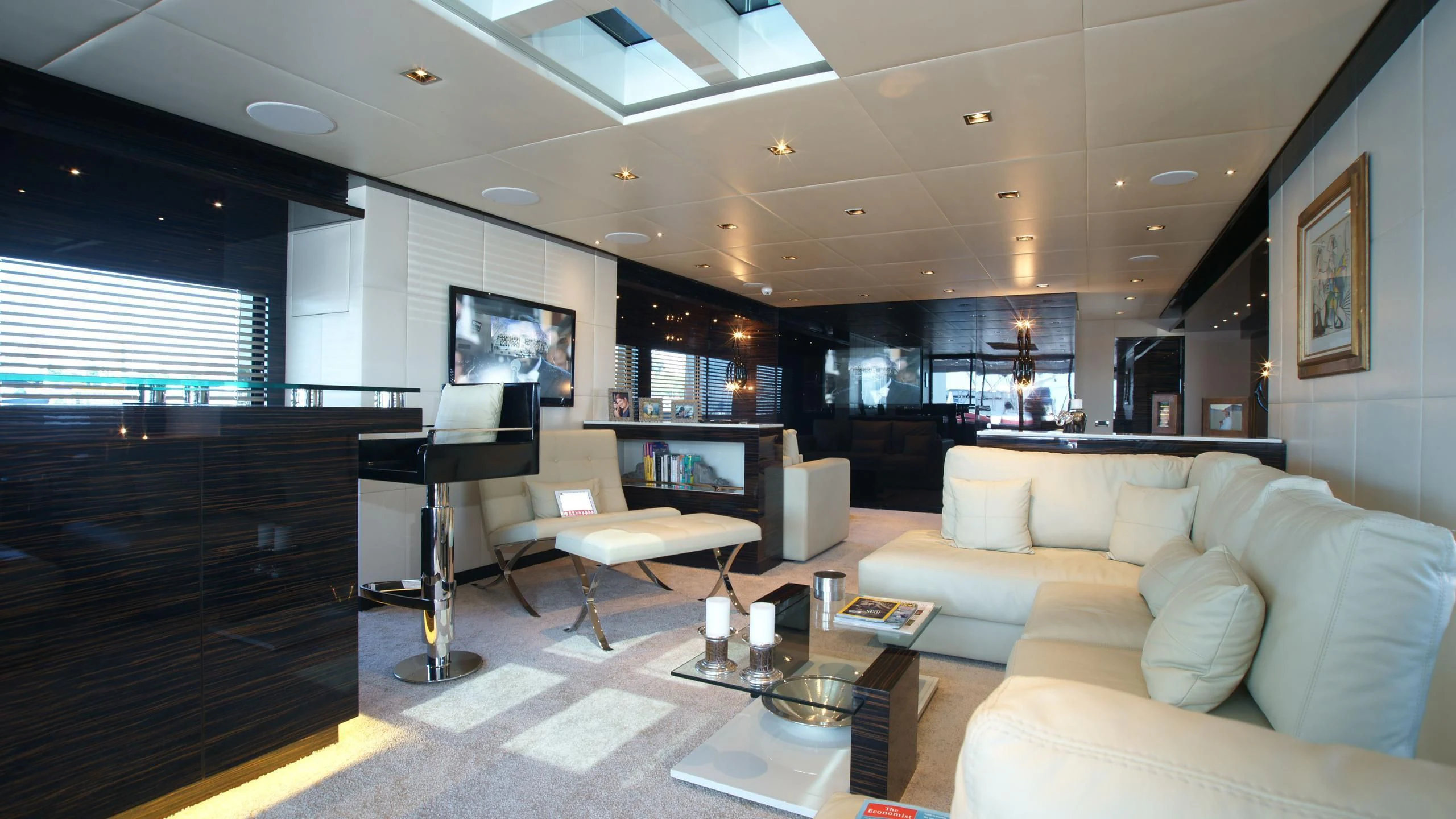 a living room with a piano aboard OCEAN CLUB Yacht for Sale