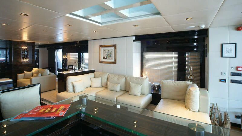 a living room with a couch and a table aboard OCEAN CLUB Yacht for Sale