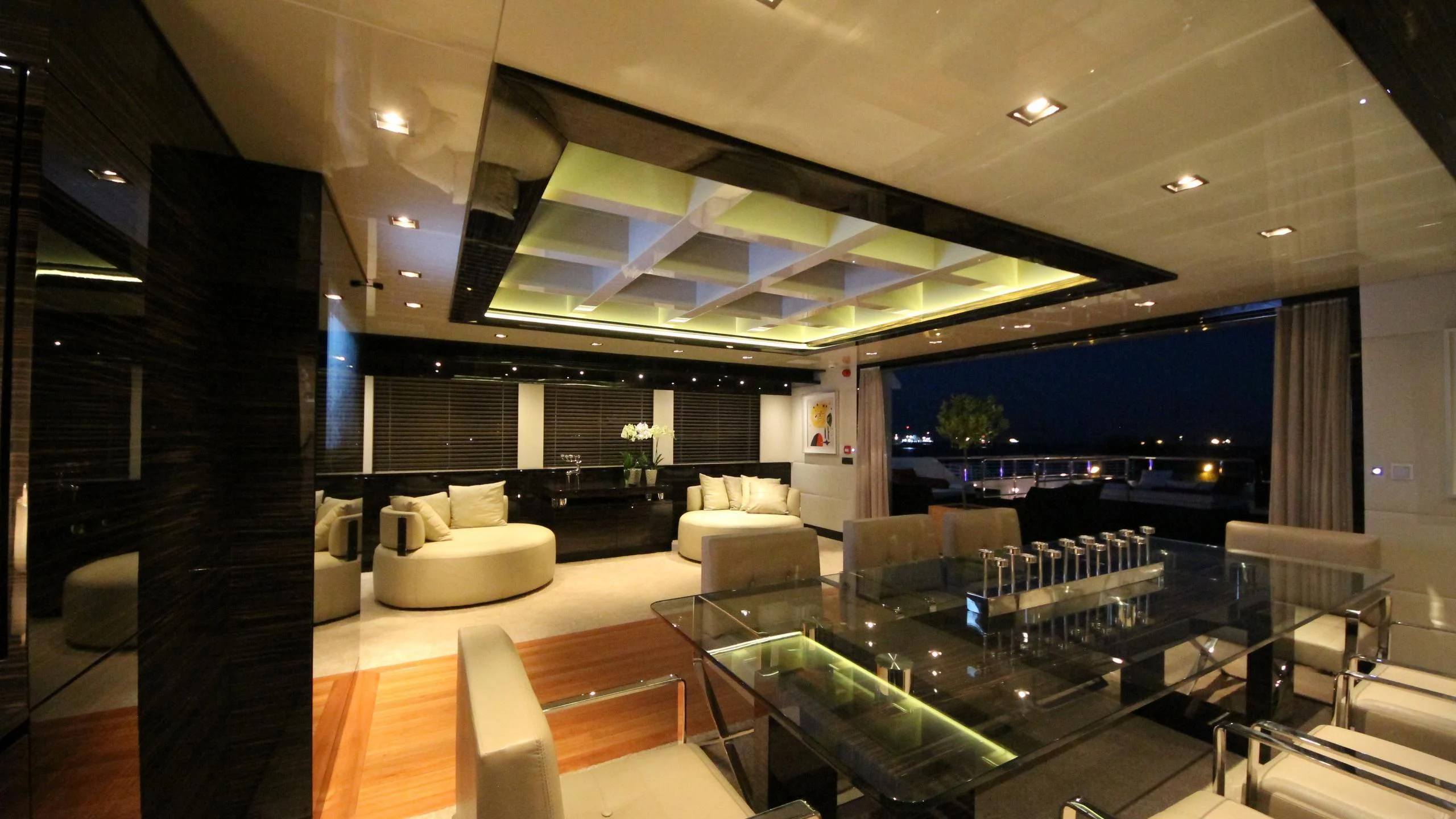a room with a large glass wall and a large window with a view of the city aboard OCEAN CLUB Yacht for Sale