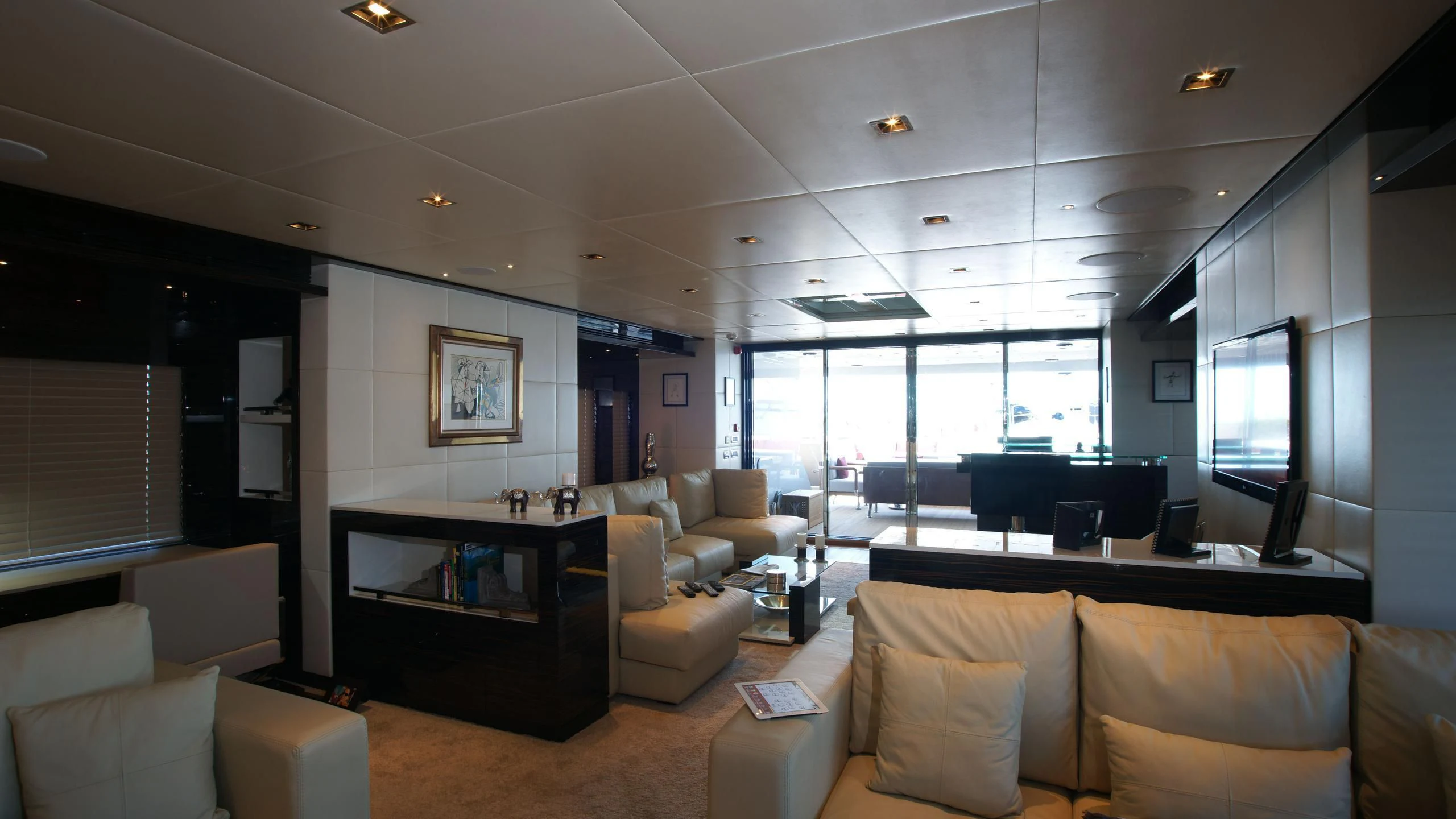 a living room with a couch and a tv aboard OCEAN CLUB Yacht for Sale
