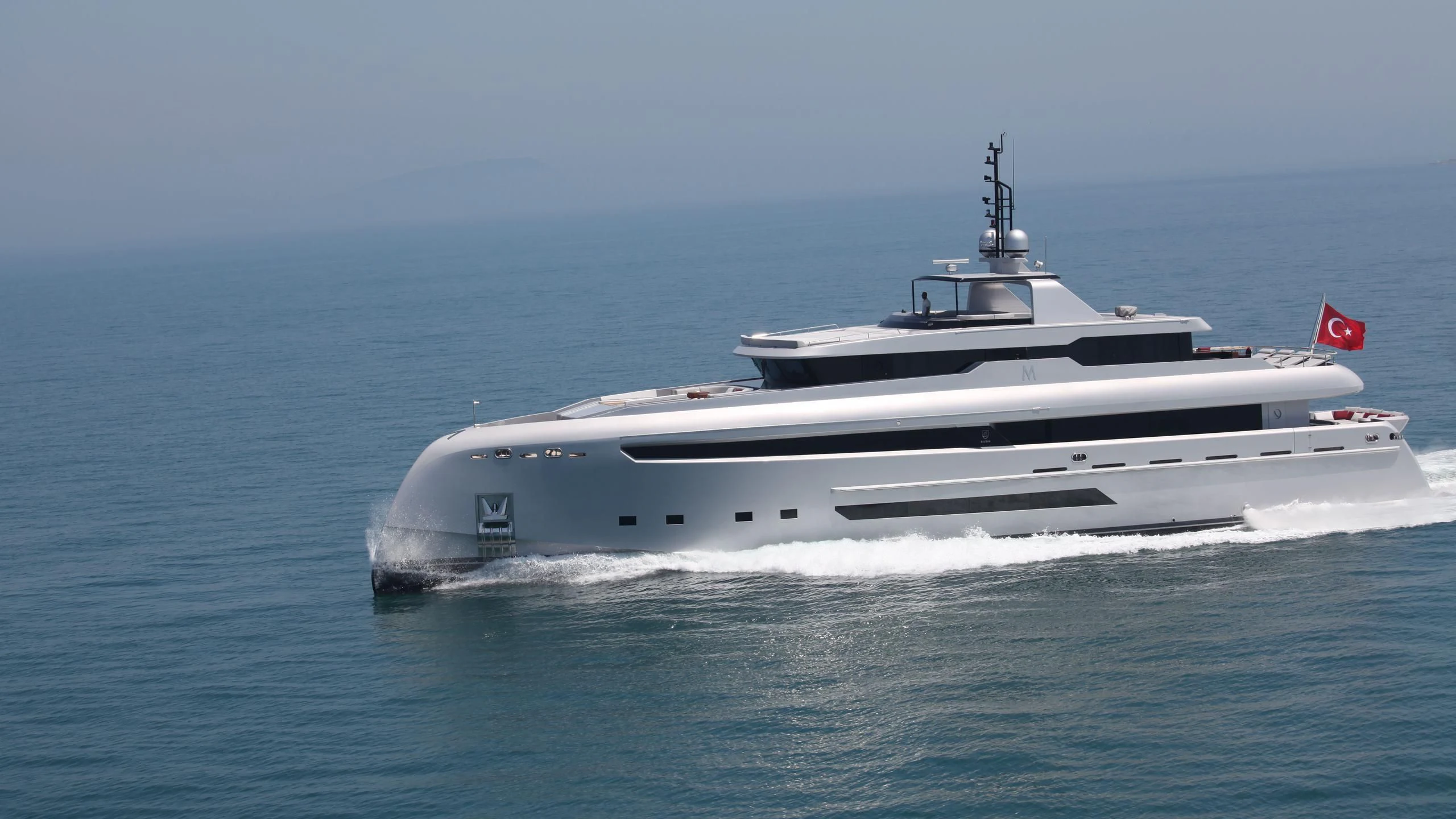 a white boat in the water aboard OCEAN CLUB Yacht for Sale
