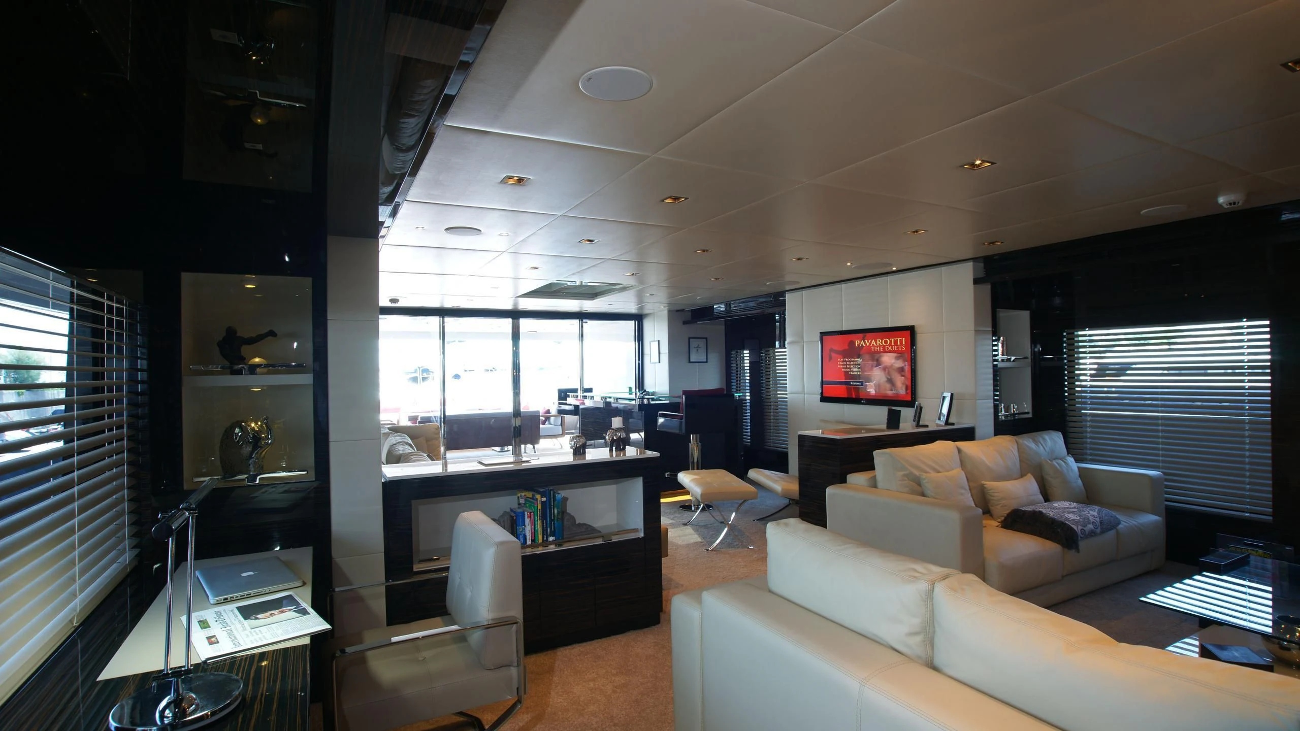 a living room with a large window aboard OCEAN CLUB Yacht for Sale