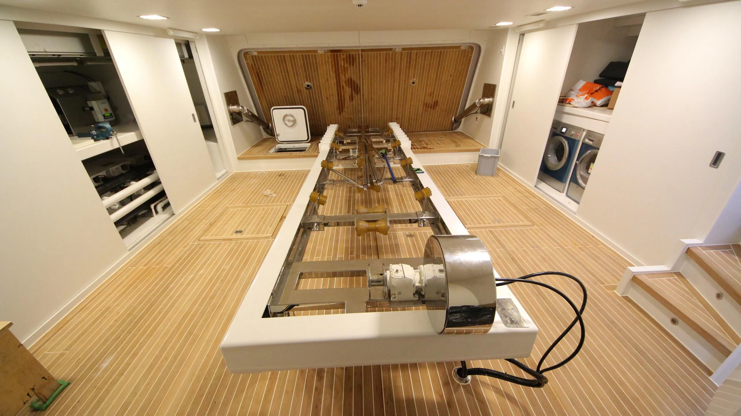 a room with a wood floor and a computer on the floor aboard OCEAN CLUB Yacht for Sale
