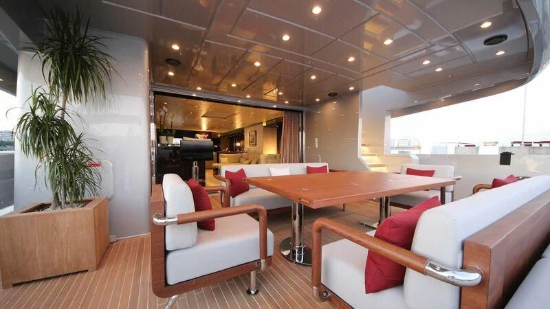 a room with a table and chairs aboard OCEAN CLUB Yacht for Sale