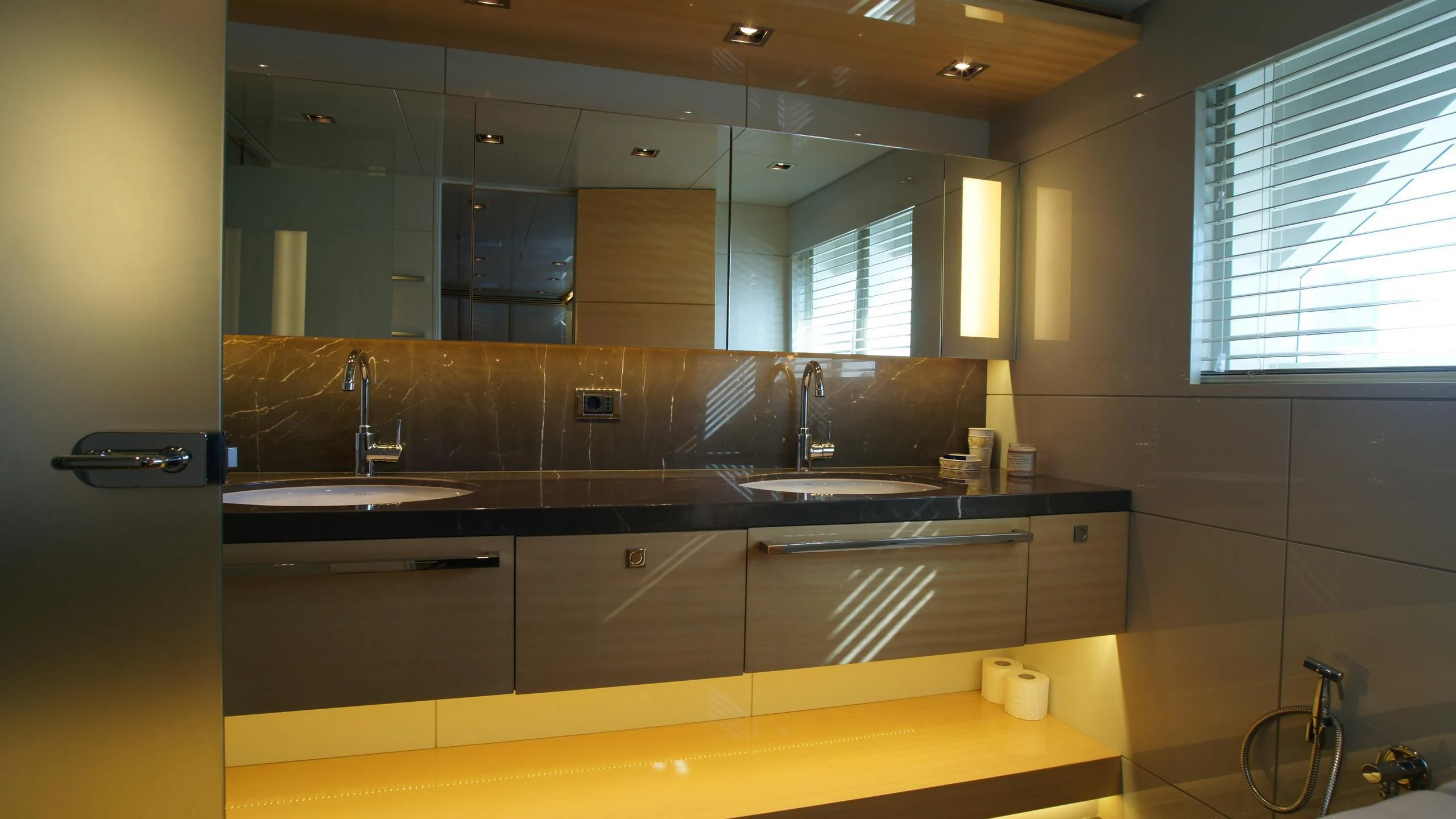 a bathroom with a sink and a mirror aboard OCEAN CLUB Yacht for Sale