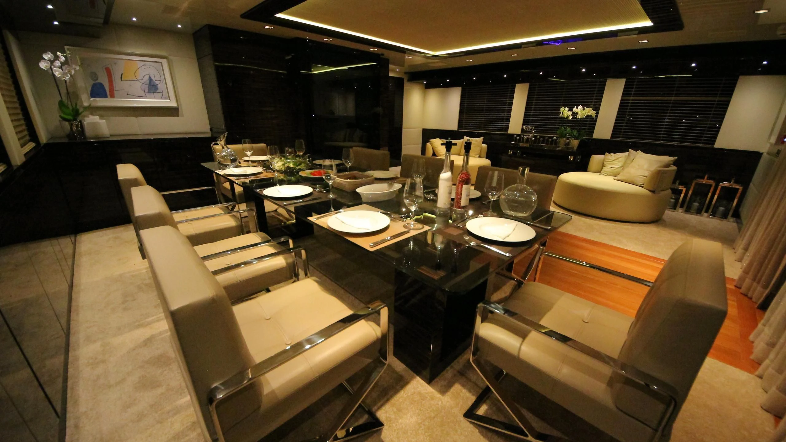 a large room with a table and chairs aboard OCEAN CLUB Yacht for Sale