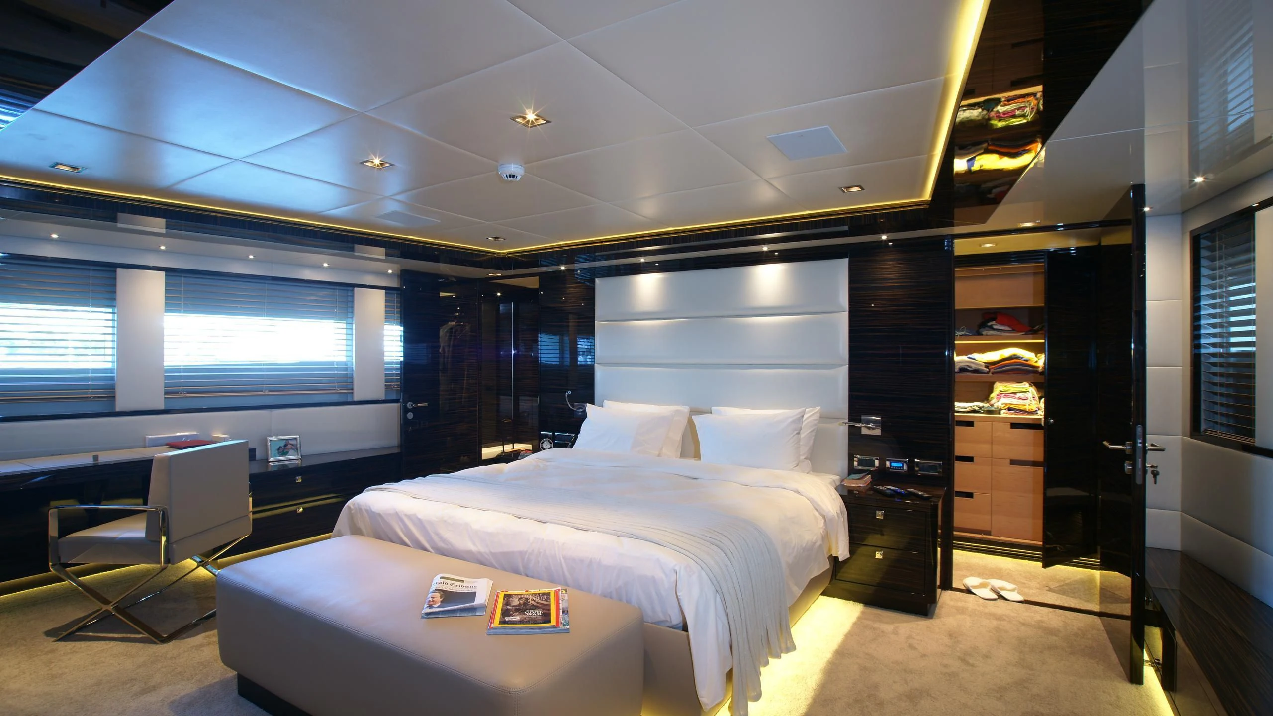 a room with a bed and a desk aboard OCEAN CLUB Yacht for Sale