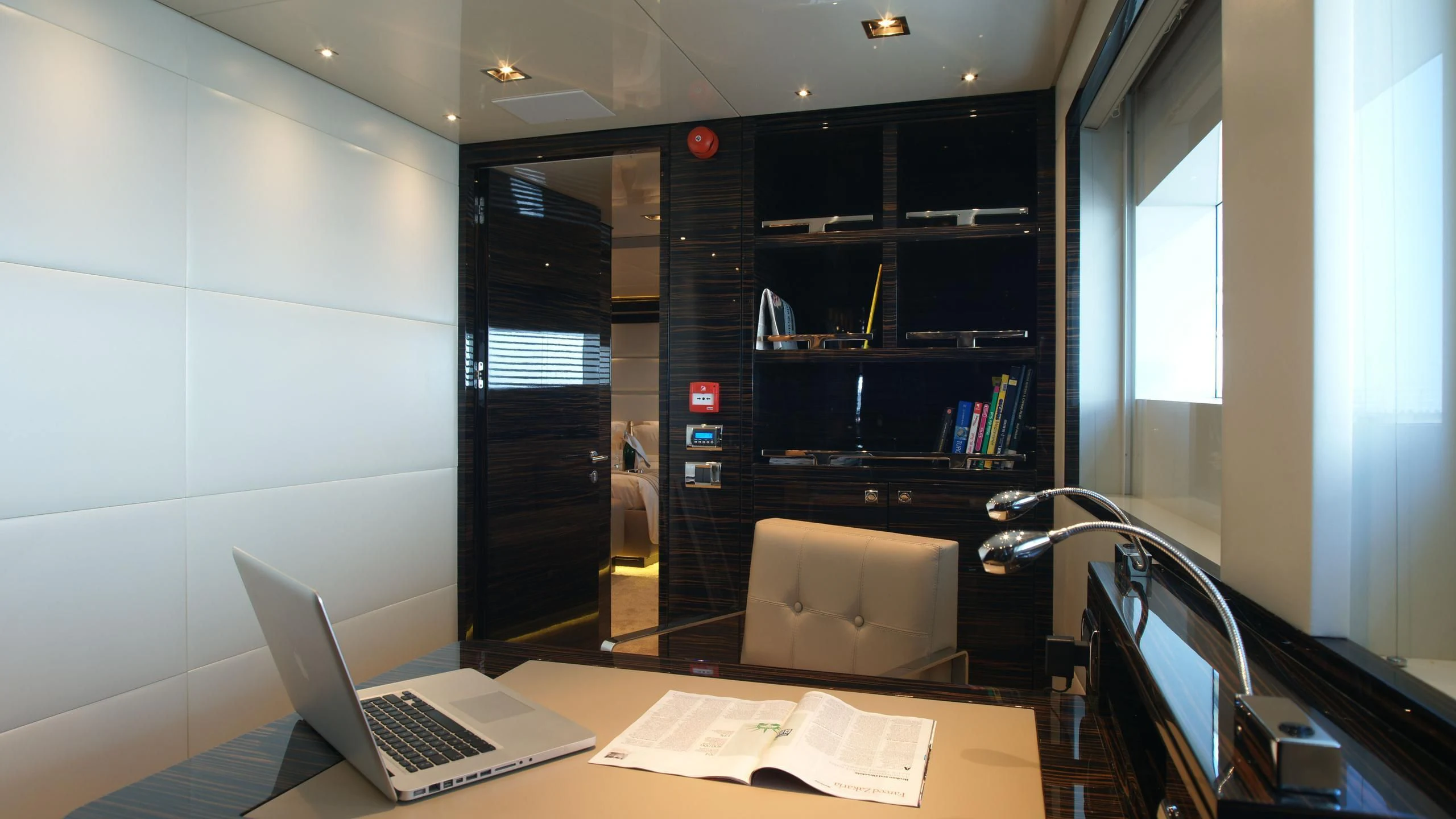 a laptop on a desk aboard OCEAN CLUB Yacht for Sale