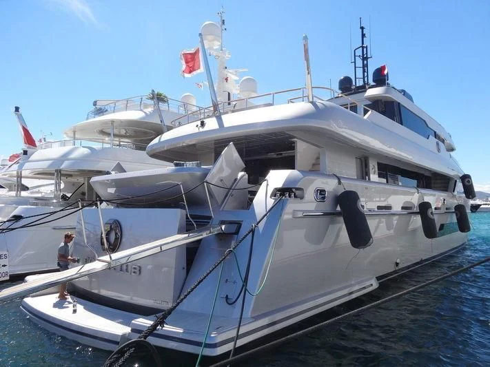 a large white boat on a dock aboard OCEAN CLUB Yacht for Sale