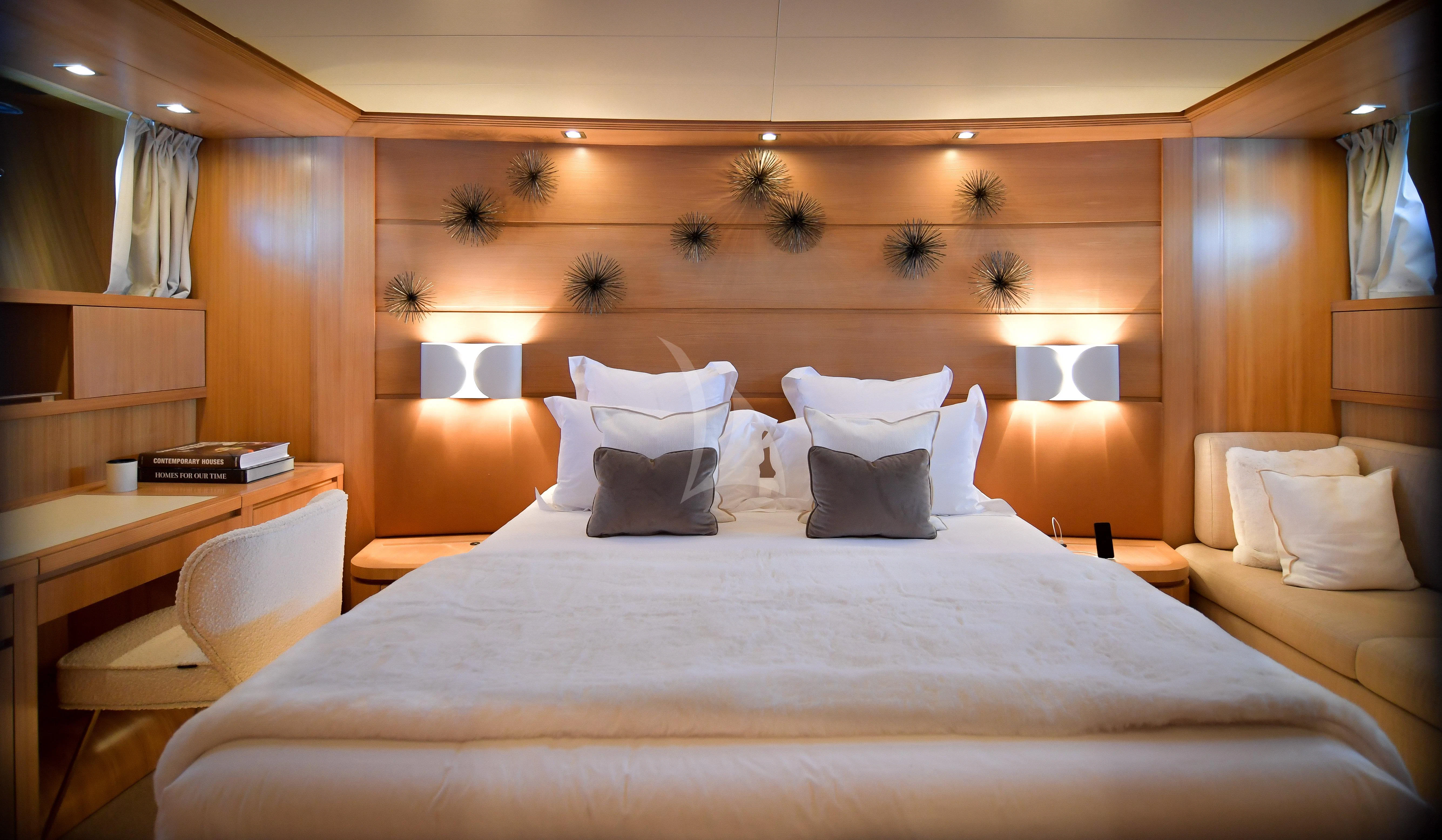 a bed with white pillows aboard FASTER Yacht for Sale