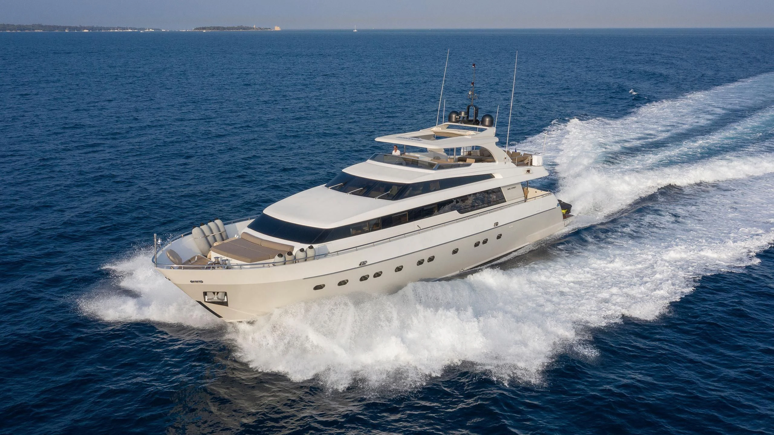 a large white ship on the water aboard FASTER Yacht for Sale