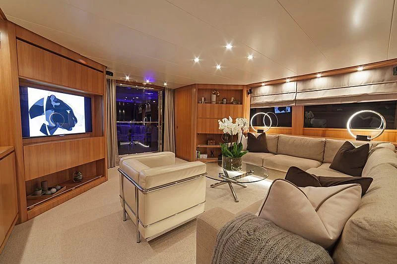 a living room with a large screen aboard FASTER Yacht for Sale