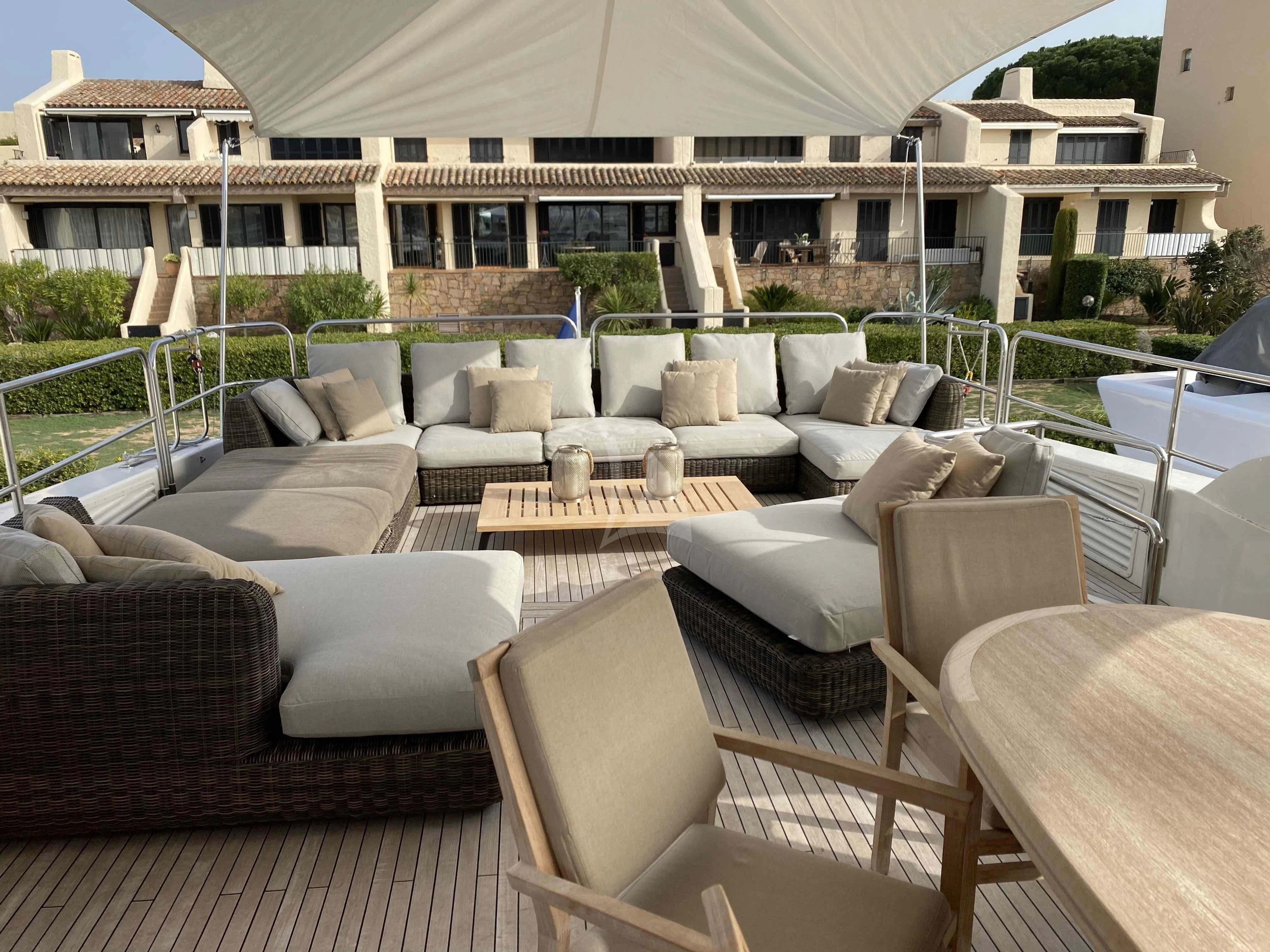 a patio with a table and chairs aboard FASTER Yacht for Sale