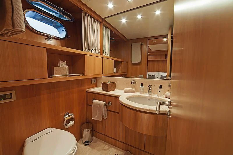 a bathroom with a large mirror aboard FASTER Yacht for Sale